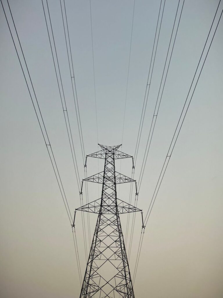 high voltage power lines against clear sky