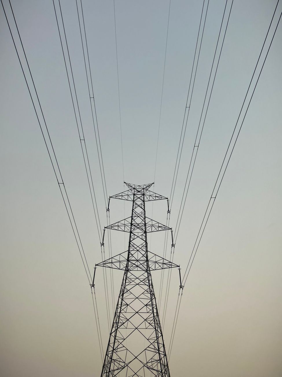 high voltage power lines against clear sky